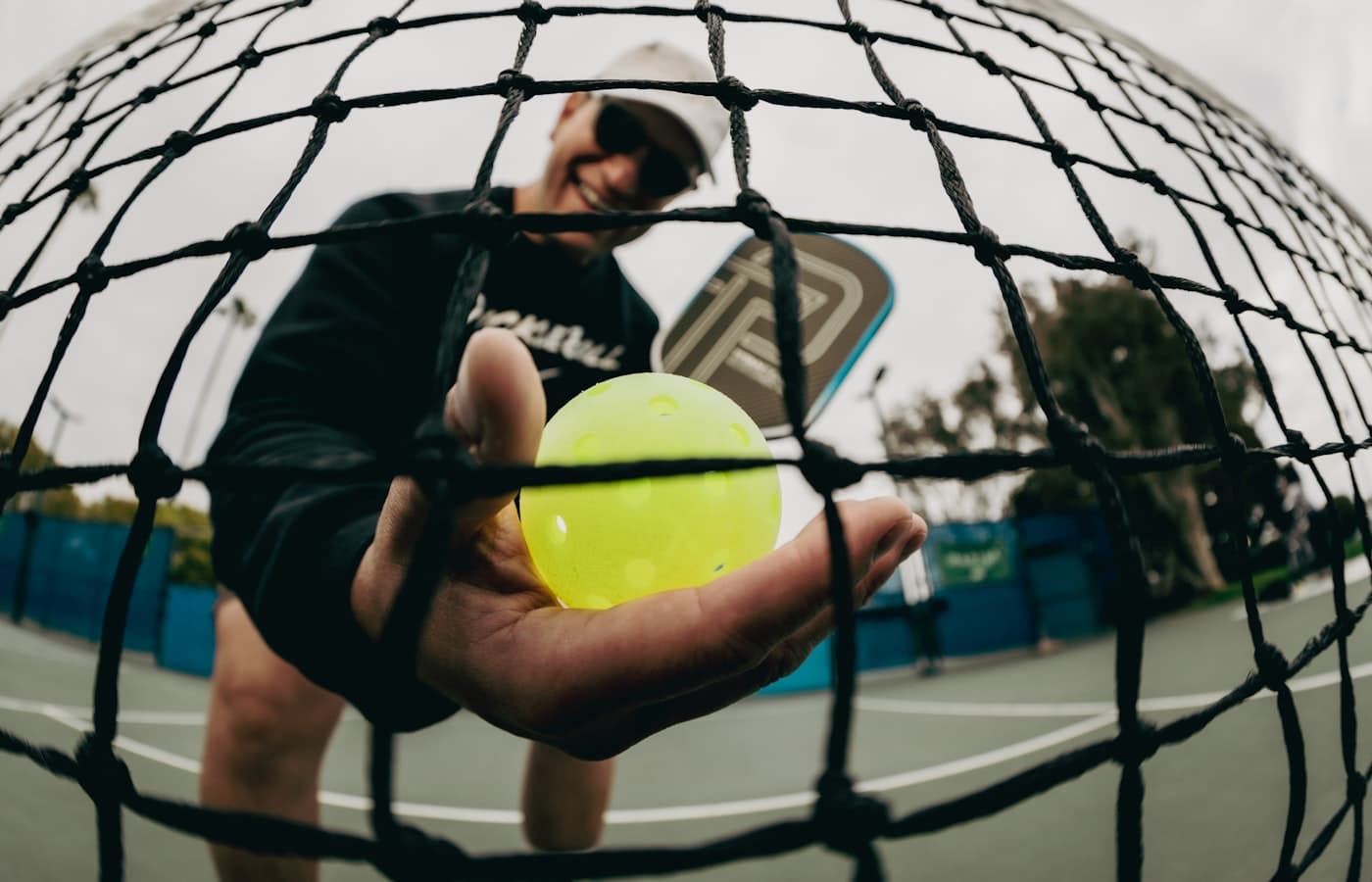 Pickleball bouncing on the court near the kitchen line during a rally